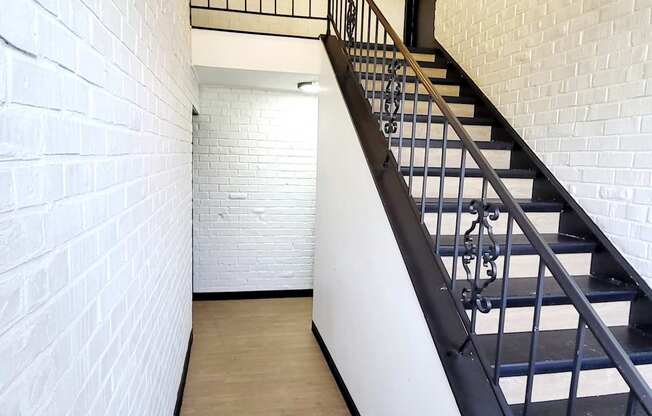 A long hallway with a staircase on the right side.