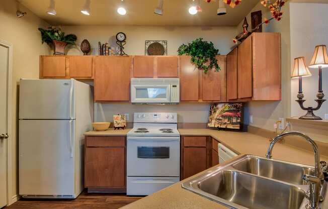 a kitchen with white appliances and wooden cabinets