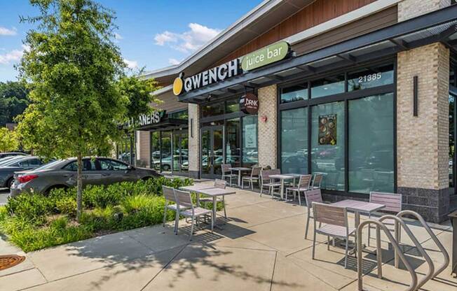 a patio outside of a restaurant with tables and chairs