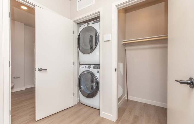 A white washing machine is in a small laundry room.