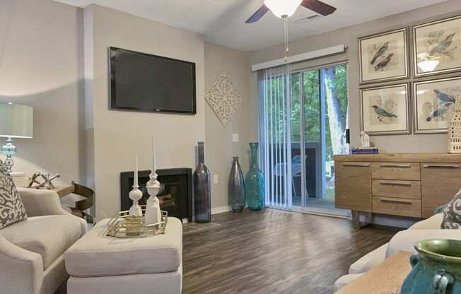 an open living room with a tv and a sliding glass door