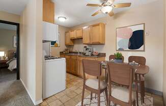 an open kitchen and dining area with a dining table and chairs