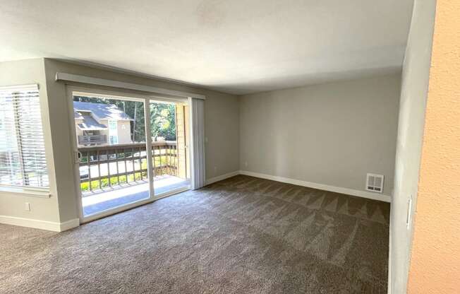 an empty living room with a patio door