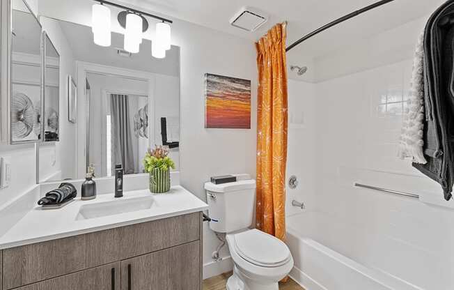 a bathroom with a toilet sink and tub and a shower