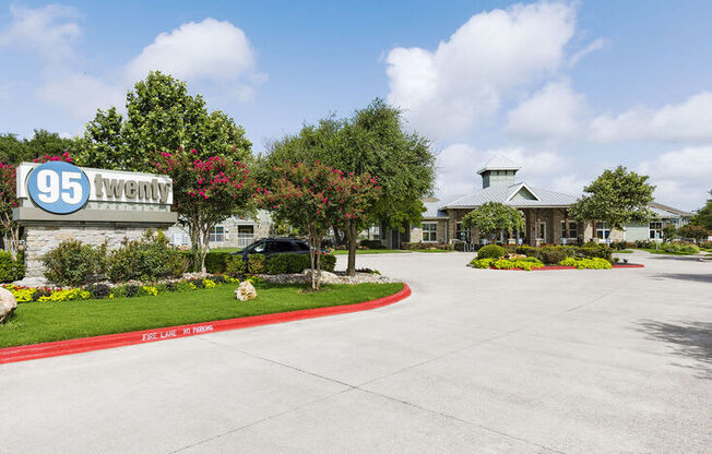 a driveway leading to a building with a sign that says 95 laurel