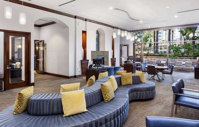 A living room with a grey couch and yellow pillows.