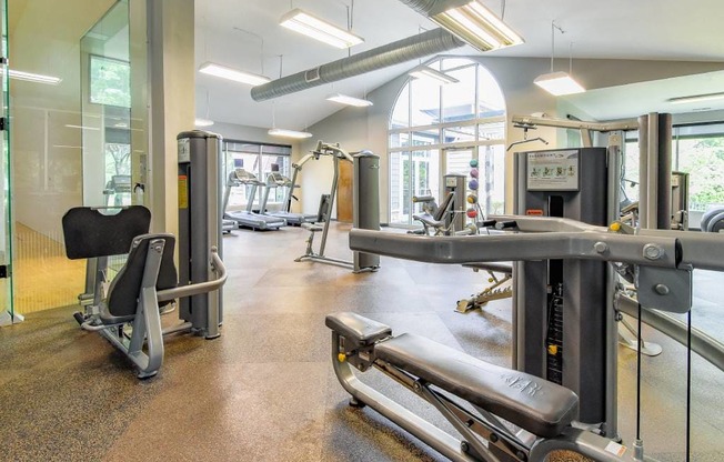 A gym with a variety of equipment including a leg press machine.