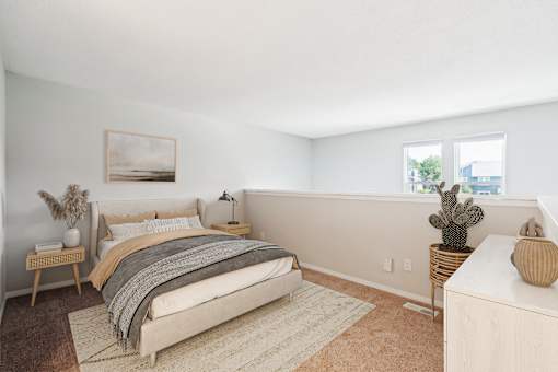A bedroom with a large bed and a cactus on the side table.