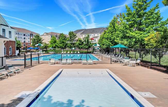 our apartments have a resort style pool with chairs and umbrellas