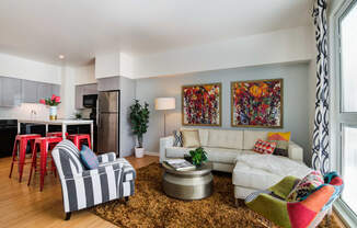 a living room filled with furniture and a large window