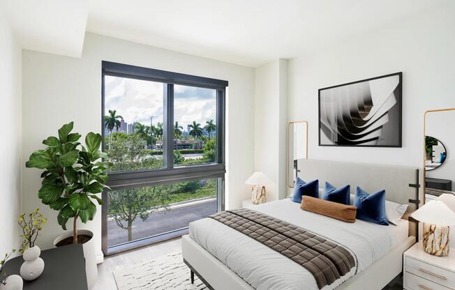Bright bedrooms at Modera Aventura offer refined finishes and tropical views framed by floor-to-ceiling windows.