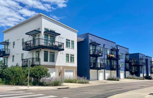 a row of apartment buildings on a city street