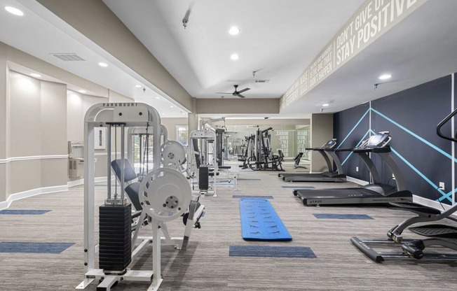 a gym with weights and cardio equipment at the estates at johnston crossing