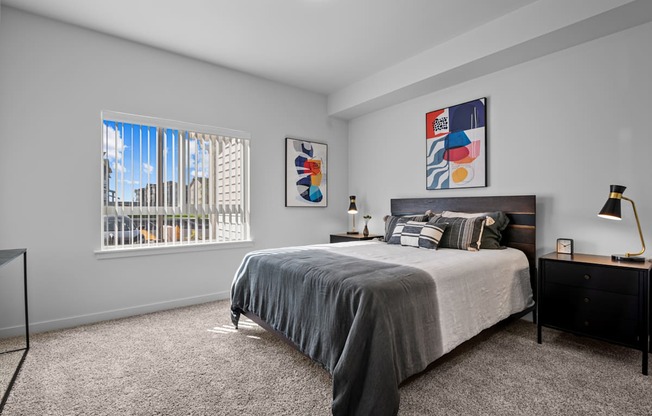 a bedroom with a bed and a large window