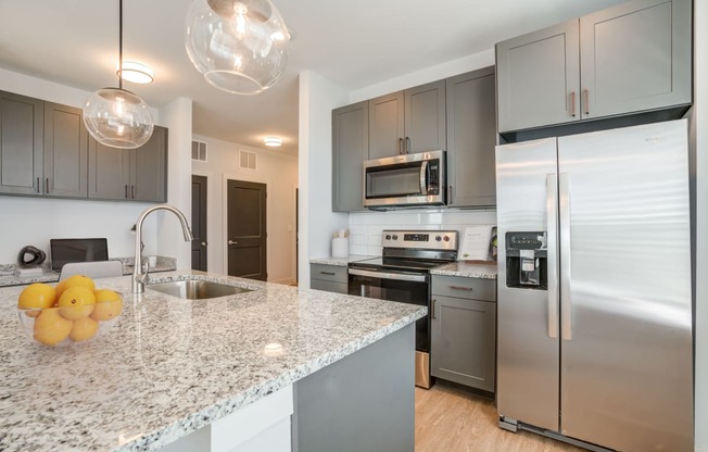 a kitchen with stainless steel appliances and granite counter tops