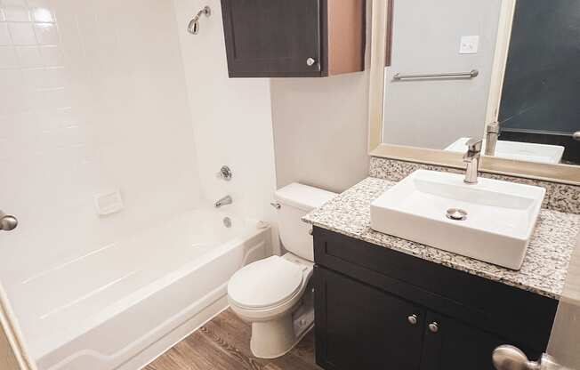 an empty bathroom with a sink toilet and shower