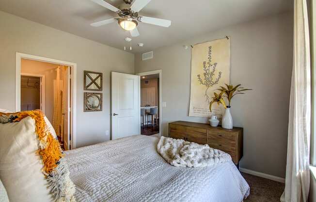 a bedroom with a bed and a ceiling fan