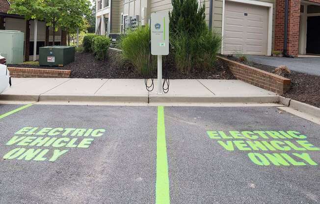 the electric vehicle only parking lot is painted green on the street