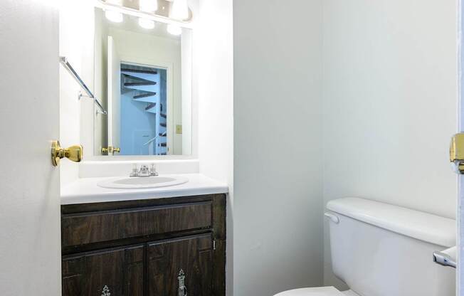 A white sink is in front of a mirror in a bathroom at Spring Creek Townhomes Apartments, Springfield, IL