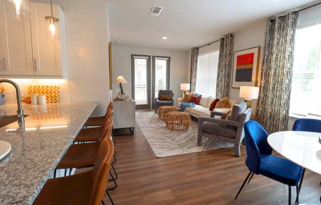 a living room with a kitchen and a dining room