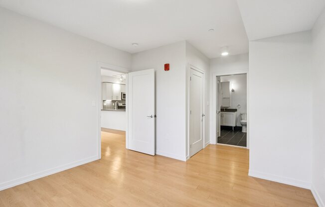 Bedroom with wooden floors and white walls  at Park77 Apartments, Cambridge, MA