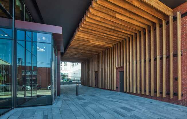 the facade of a building with a large glass door and a walkway