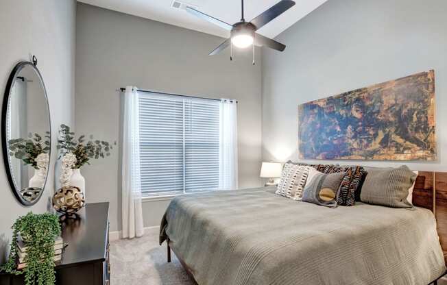 a bedroom with a bed and a ceiling fan