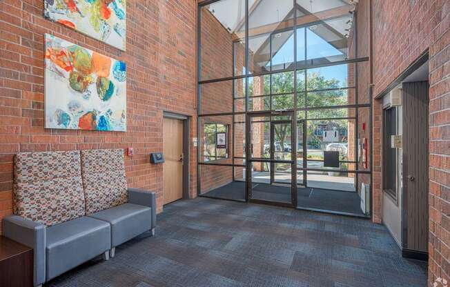 a lobby with a couch and a glass door