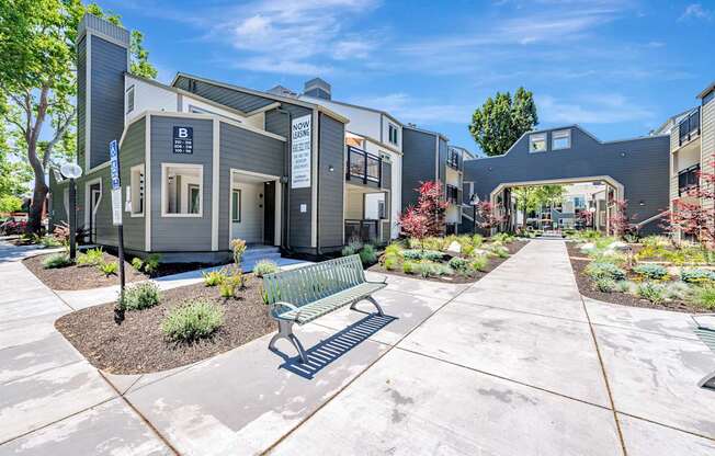 A modern building with a bench in front of it.