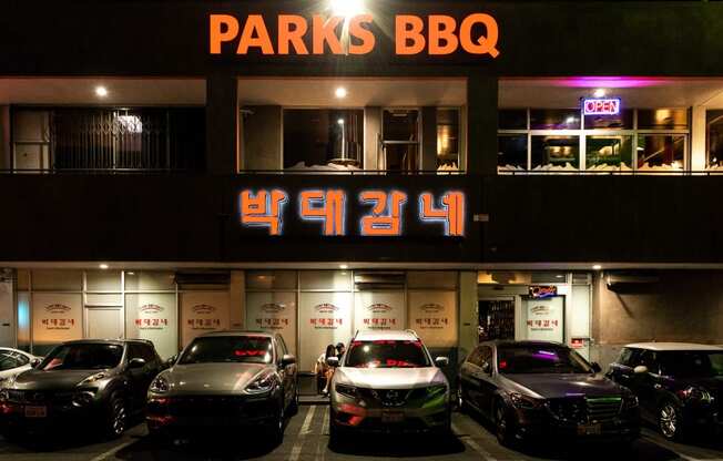 a parking lot in front of a building with a sign that reads parks bbq