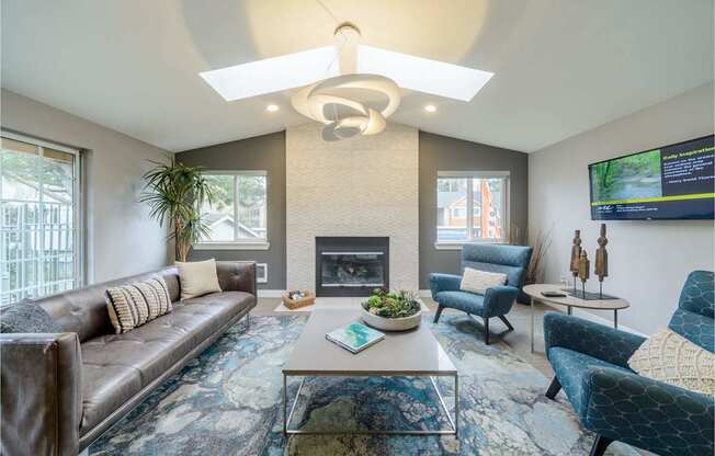 A living room with a fireplace and a TV mounted on the wall.