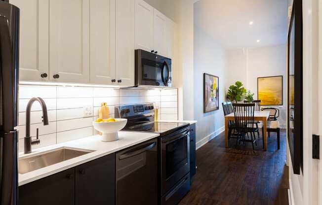a kitchen and dining room with a sink and a microwave at The Irvine, Philadelphia, Pennsylvania