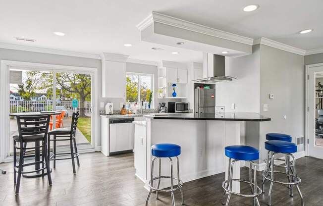 A kitchen with a bar stool and a counter.