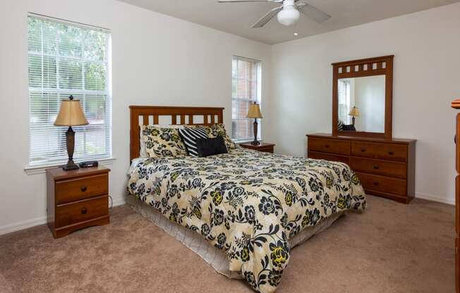 Bedroom with two windows and ceiling fan at Regency Gates in Mobile, AL