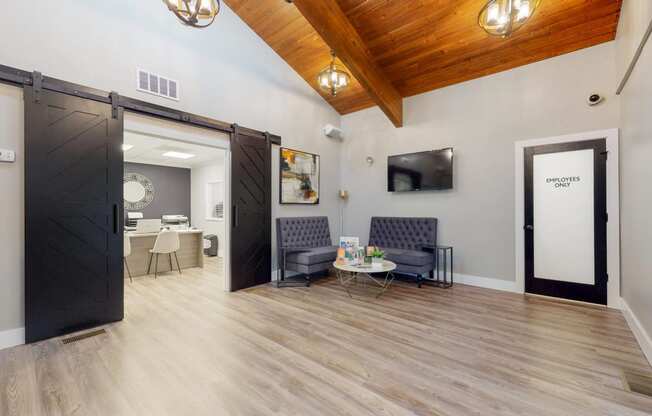 a living room with a wooden floor and a sliding barn door