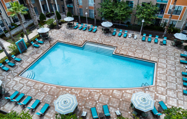 Birdseye view of large swimming pool and sundeck centered in luxury Orlando apartment community