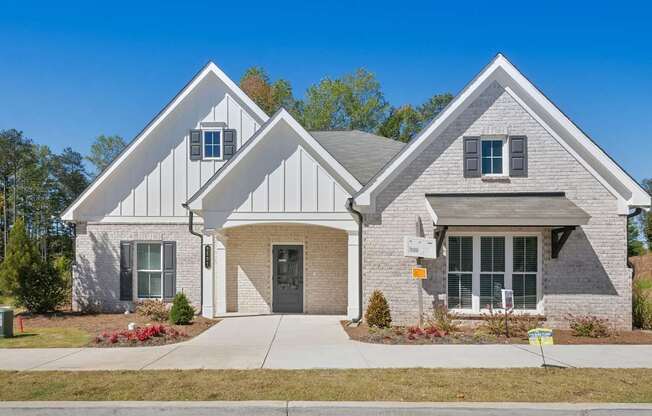 a brick house with a sidewalk in front of it