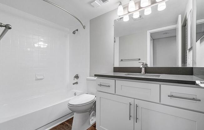 a white sink sitting under a mirror
