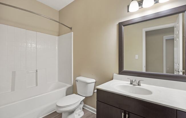 a bathroom with a sink toilet and a mirror