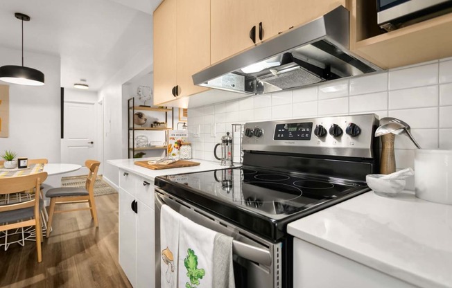 a kitchen with a stove top oven and a sink