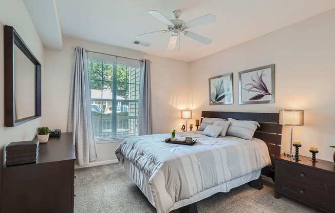 a bedroom with a bed and a ceiling fan