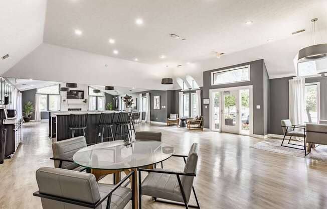 A modern dining room with a glass table and chairs