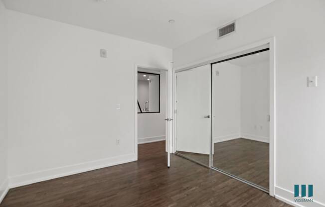 Bedroom with Mirrored Closet, Vinyl Flooring, and Recessed Lighting