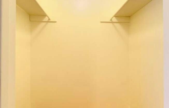 A hallway with a carpeted floor and white walls.