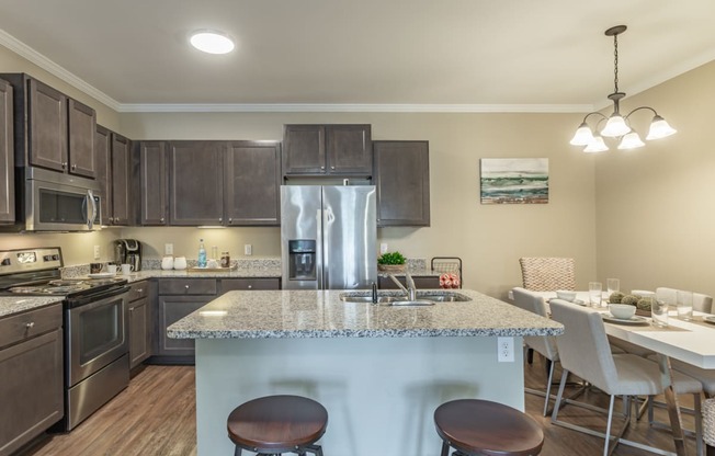 an open kitchen and dining area with a granite counter top