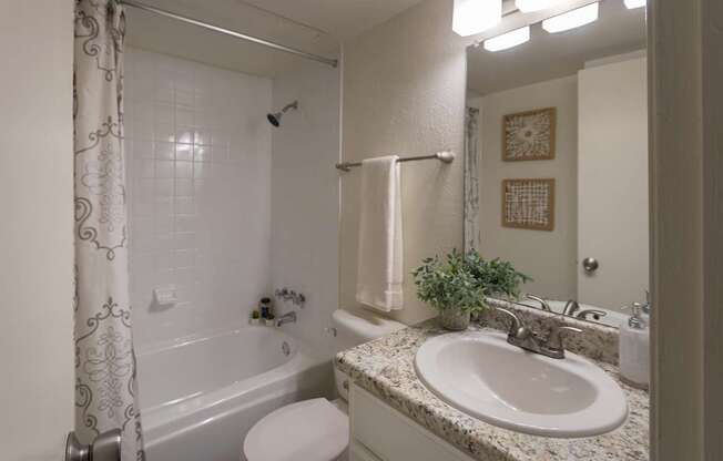 A bathroom with a white vanity in a 1 bedroom, 1 bath 554 sq ft apartment home at The Biltmore Apartments located in the Vickery Midtown neighborhood of Dallas, TX.