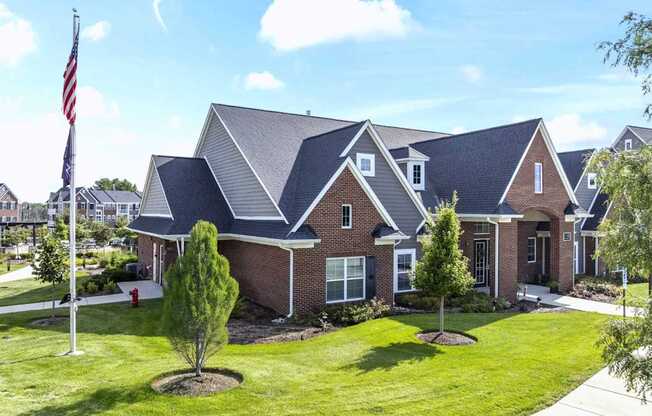 A house with a flag on a pole in front of it.