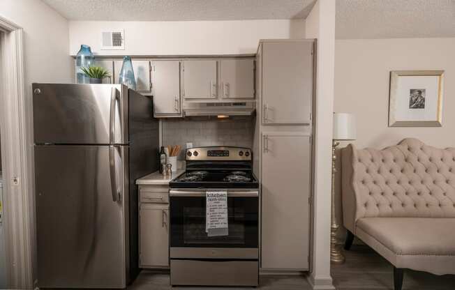 a kitchen with stainless steel appliances and a stainless steel refrigerator