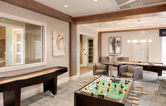 Billiard and gaming room with table and chairs, Foosball table, Shuffleborad table, billiards