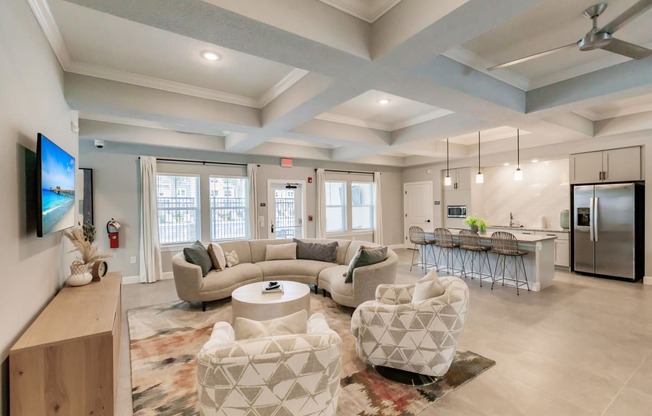 community lounge area with chairs and tables at Vantage Luxury Apartments in Cape Coral, FL